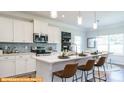 Modern kitchen featuring white cabinets, a large island, and stainless steel appliances at 6324 Honor Ave, Midland, NC 28107