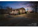 Brick ranch house with a deck, situated on a spacious lot at 7392 Reeps Grove Church Rd, Vale, NC 28168