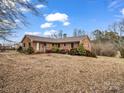 Brick ranch home offering curb appeal and a landscaped yard at 7392 Reeps Grove Church Rd, Vale, NC 28168