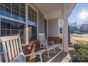 Relaxing front porch with two rocking chairs and side table at 1037 Tobin Dr, Fort Mill, SC 29715