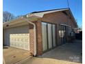 Attached garage with white door and brick exterior at 108 Greenview Dr, Kannapolis, NC 28081