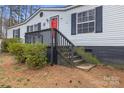 Low angle of the front of a well-kept home showing painted foundation, steps, and a vibrant red door at 114 Catawba Woods Ct, Belmont, NC 28012