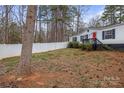 A well-manicured front yard featuring a white picket fence and a charming home with an American flag at 114 Catawba Woods Ct, Belmont, NC 28012