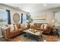 Living Room with brown leather sectional sofa and large artwork at 114 E 5Th Ave, Gastonia, NC 28052