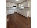 Renovated kitchen, white cabinets, and hardwood floors at 1325 Eastview Ext, Shelby, NC 28152