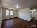 An inviting living room with rich wood floors, neutral walls, and natural light from the window at 1325 Eastview Ext, Shelby, NC 28152