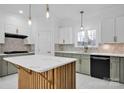 Modern kitchen with green cabinets, white countertops, and a large island at 13833 Jonathans Ridge Rd, Charlotte, NC 28227