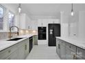 Modern kitchen with green cabinets, white countertops, and a large island at 13833 Jonathans Ridge Rd, Charlotte, NC 28227