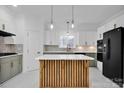 Modern kitchen with green cabinets, white countertops, and a large island at 13833 Jonathans Ridge Rd, Charlotte, NC 28227