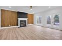 Spacious living room featuring a fireplace and wood accent wall at 13833 Jonathans Ridge Rd, Mint Hill, NC 28227