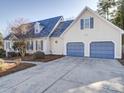 Two-story home featuring a two-car garage and neatly landscaped yard at 148 Tetbury Ne Ave, Concord, NC 28025