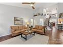 Open living room with hardwood floors, a staircase, and a view into the kitchen at 16341 Autumn Cove Ln, Huntersville, NC 28078