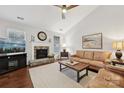 Spacious living room with a stone fireplace and hardwood floors at 16341 Autumn Cove Ln, Huntersville, NC 28078