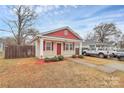 Charming single-story home with a red and beige exterior, and well-manicured landscaping at 208 Lakewood Ave, Charlotte, NC 28208