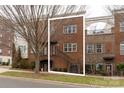 Brick three-story townhome with front entrance and landscaping at 211 Harbour Place Dr, Davidson, NC 28036