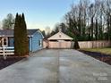 Spacious driveway with carport and wooden fence at 235 Linda St, Salisbury, NC 28146