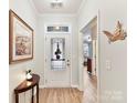 Bright foyer with wood flooring and decorative features, including a decorative front door at 3020 Sewee Ln, Waxhaw, NC 28173