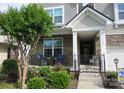 Cozy front porch with comfortable seating and a beautifully landscaped garden area at 3020 Sewee Ln, Waxhaw, NC 28173