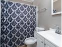 Clean bathroom with white vanity, shower, and patterned curtain at 4405 Tillman Rd, Charlotte, NC 28208