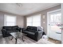 Living room with two black sofas and a glass coffee table at 4405 Tillman Rd, Charlotte, NC 28208