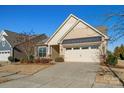 Tan colored house with a two car garage and landscaping at 5021 Redwood Grove Trl # 86, Lancaster, SC 29720