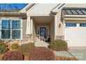 Inviting front porch with stone details and a charming door at 5021 Redwood Grove Trl # 86, Lancaster, SC 29720