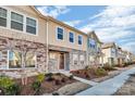 Row of townhomes showcasing similar design, landscaping, and street view at 638 Sagecroft Ln, Indian Trail, NC 28079