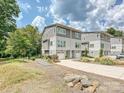 Modern townhome community featuring gray siding and attached garages at 7324 Swans Run Rd, Charlotte, NC 28226