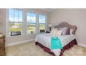 Cozy bedroom with a tufted headboard and plenty of natural light at 7673 Bainbridge Rd, Sherrills Ford, NC 28673