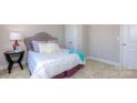 Simple bedroom with a tufted headboard and neutral color scheme at 7673 Bainbridge Rd, Sherrills Ford, NC 28673