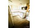 Modern white kitchen with updated appliances and wood countertops at 1016 Patricia Ave, Harrisburg, NC 28075