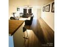 Bright living room with hardwood floors and a view of the kitchen at 1016 Patricia Ave, Harrisburg, NC 28075