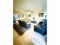 Spacious living room features hardwood floors and comfy leather furniture at 1016 Patricia Ave, Harrisburg, NC 28075