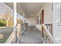Front porch with wooden railings and steps leading to the front door at 1028 White Ln, Gastonia, NC 28052