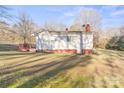 White house with red brick base, deck, and yard at 1028 White Ln, Gastonia, NC 28052