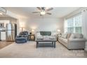 Open living room with neutral carpeting and a ceiling fan at 107 Jeffrey St, Fort Mill, SC 29715