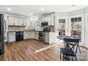 Updated kitchen boasts granite counters, stainless steel appliances, and wood flooring at 10705 Whitfield Ridge Dr, Charlotte, NC 28277