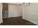 Bright dining room features hardwood floors, chandelier and decorative wall trim at 1136 Yellow Springs Dr, Huntersville, NC 28078