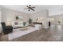 Bright living room with hardwood floors, stylish furniture, modern ceiling fan and decor at 1178 Valley St, Statesville, NC 28677