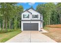 Two-story house with white siding, gray garage door, and a spacious driveway at 180 Bowman Rd, Statesville, NC 28625
