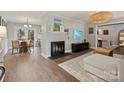 Spacious living room featuring a fireplace and large TV at 2013 Tyvola Rd, Charlotte, NC 28210