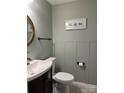 Stylish half bathroom featuring wainscoting, a modern sink, and neutral paint color at 204 Riverview Ter, Lake Wylie, SC 29710
