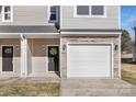 Front view of duplex featuring stonework and double garage at 2109 Gemway Dr, Charlotte, NC 28216