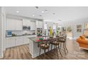 Modern kitchen with white cabinets, granite countertops, and a kitchen island at 2151 Black Forest Cv, Concord, NC 28027