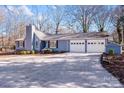 Newly painted light blue exterior boasts a two-car garage and mature trees at 217 E Old Highway 74 Hwy # 4, Monroe, NC 28112