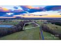 Aerial view showcasing expansive property with surrounding fields at 50 Berea Church Quincy Rd, Hiddenite, NC 28636