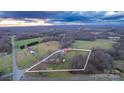Aerial view of a house on a large lot with surrounding farmland at 50 Berea Church Quincy Rd, Hiddenite, NC 28636
