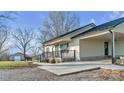 House exterior featuring a covered porch and attached garage at 50 Berea Church Quincy Rd, Hiddenite, NC 28636