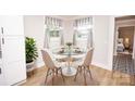 Cozy dining area featuring a round glass table with seating for four near sunlit windows at 5020 Foster Rd, Cleveland, NC 27013