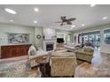 Open living room featuring hardwood floors, fireplace and multiple seating areas at 55327 Derringer Ave, Fort Mill, SC 29707